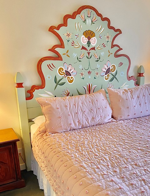 Custom built by local carpenter Gary Doubledee, and hand-painted by artist-in-residence Marie-Clare Treseder Gorham, this unique headboard offers a quintessentially Carmel backdrop for your stay at Hofsas House. 